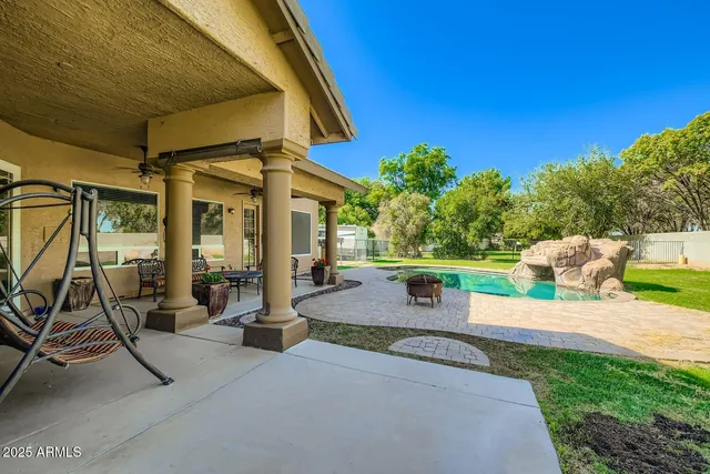 a view of a patio with table and chairs and potted plants
