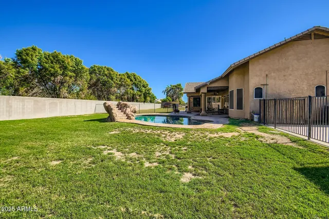 a view of an house with backyard of house and outdoor seating