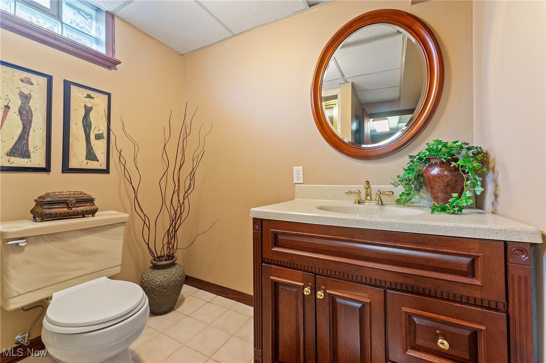 3314 Decamp Road Youngstown, OH 44511 - Photo 27 of 31 Bathroom featuring vanity, a paneled ceiling, tile patterned floors, and toilet