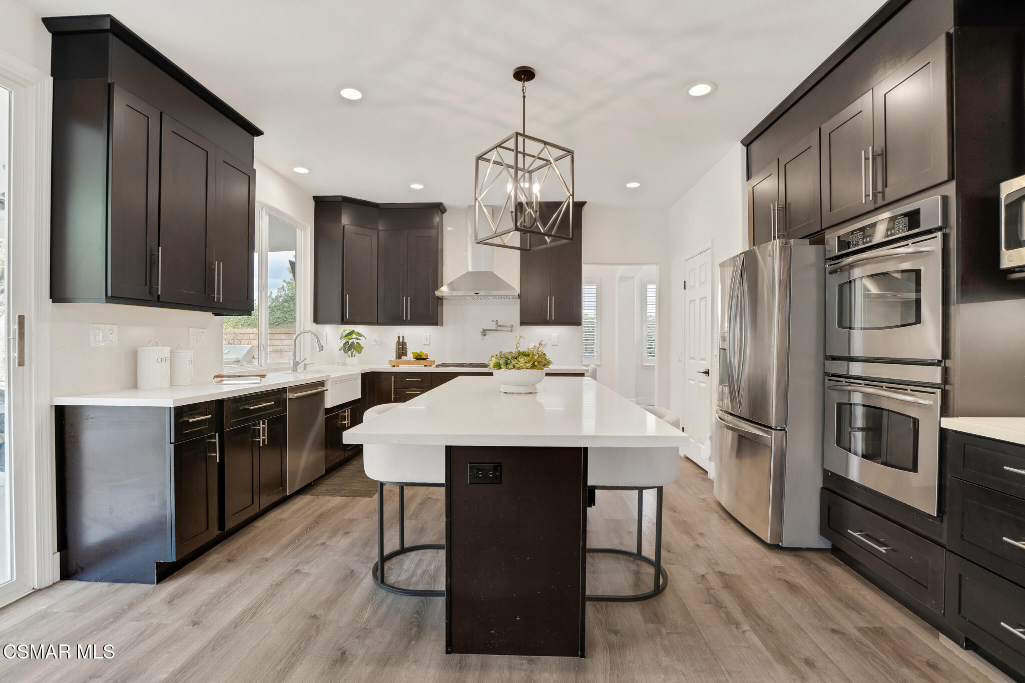 2339 Rudolph Drive Simi Valley, CA 93065 - Photo 13 of 61 a kitchen with stainless steel appliances kitchen island granite countertop a sink refrigerator and cabinets