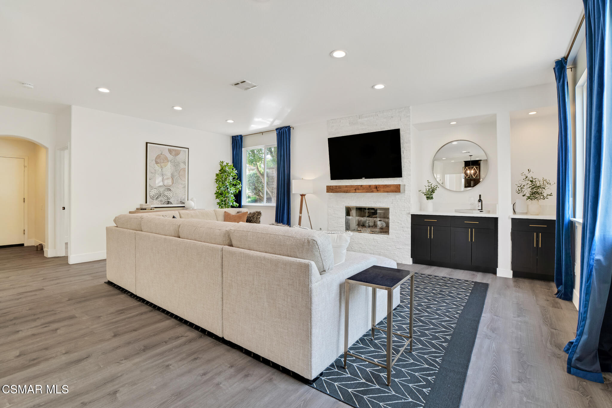 2339 Rudolph Drive Simi Valley, CA 93065 - Photo 17 of 61 a living room with furniture a flat screen tv and a fireplace