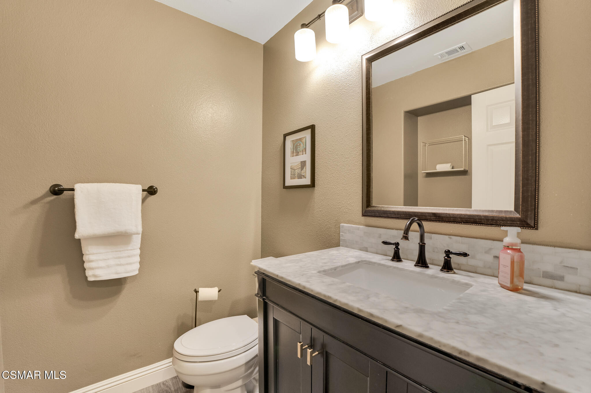 2339 Rudolph Drive Simi Valley, CA 93065 - Photo 19 of 61 a bathroom with a granite countertop sink a toilet and mirror