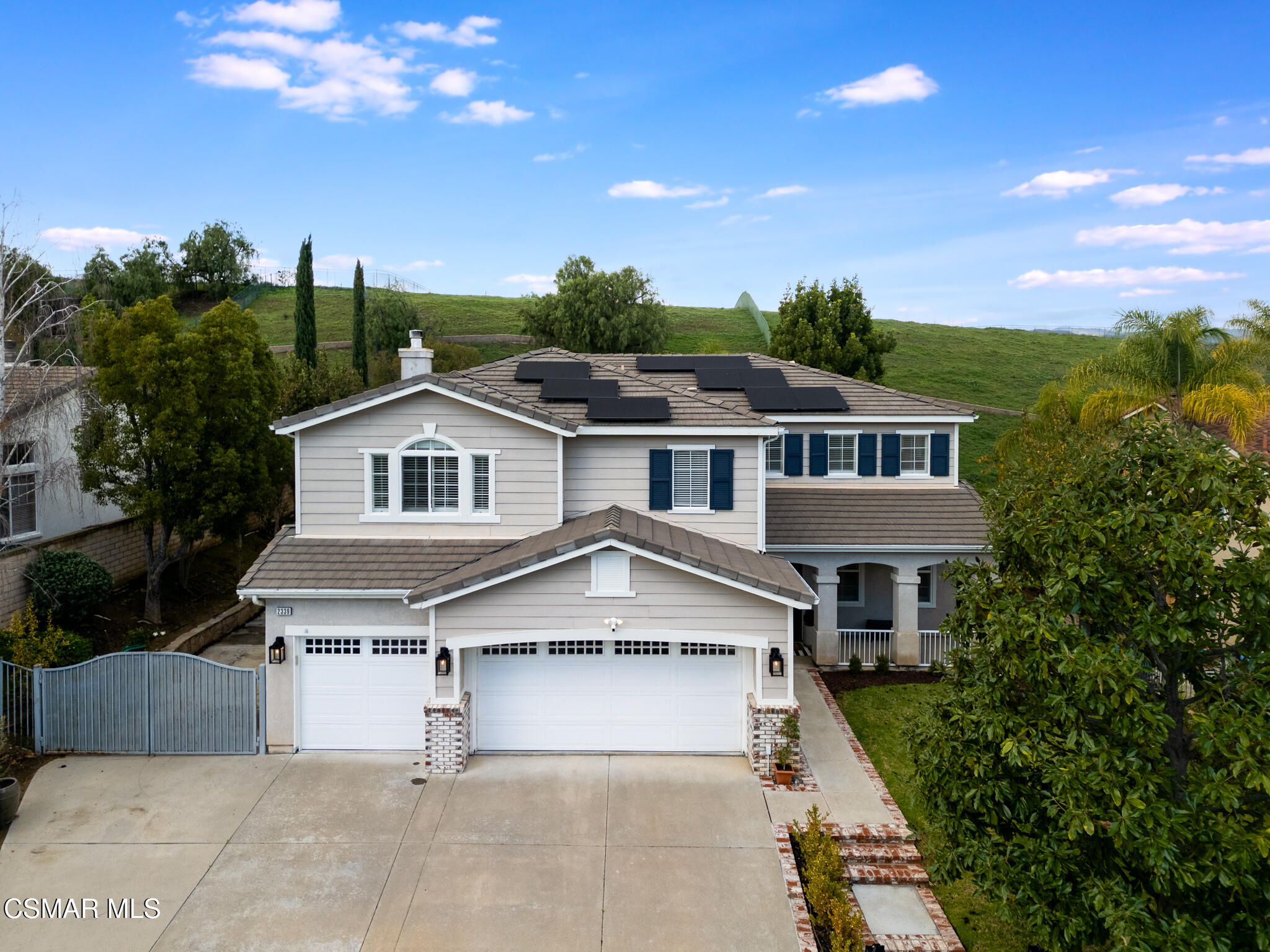2339 Rudolph Drive Simi Valley, CA 93065 - Photo 2 of 61 a view of a white house next to a yard with potted plants and large trees