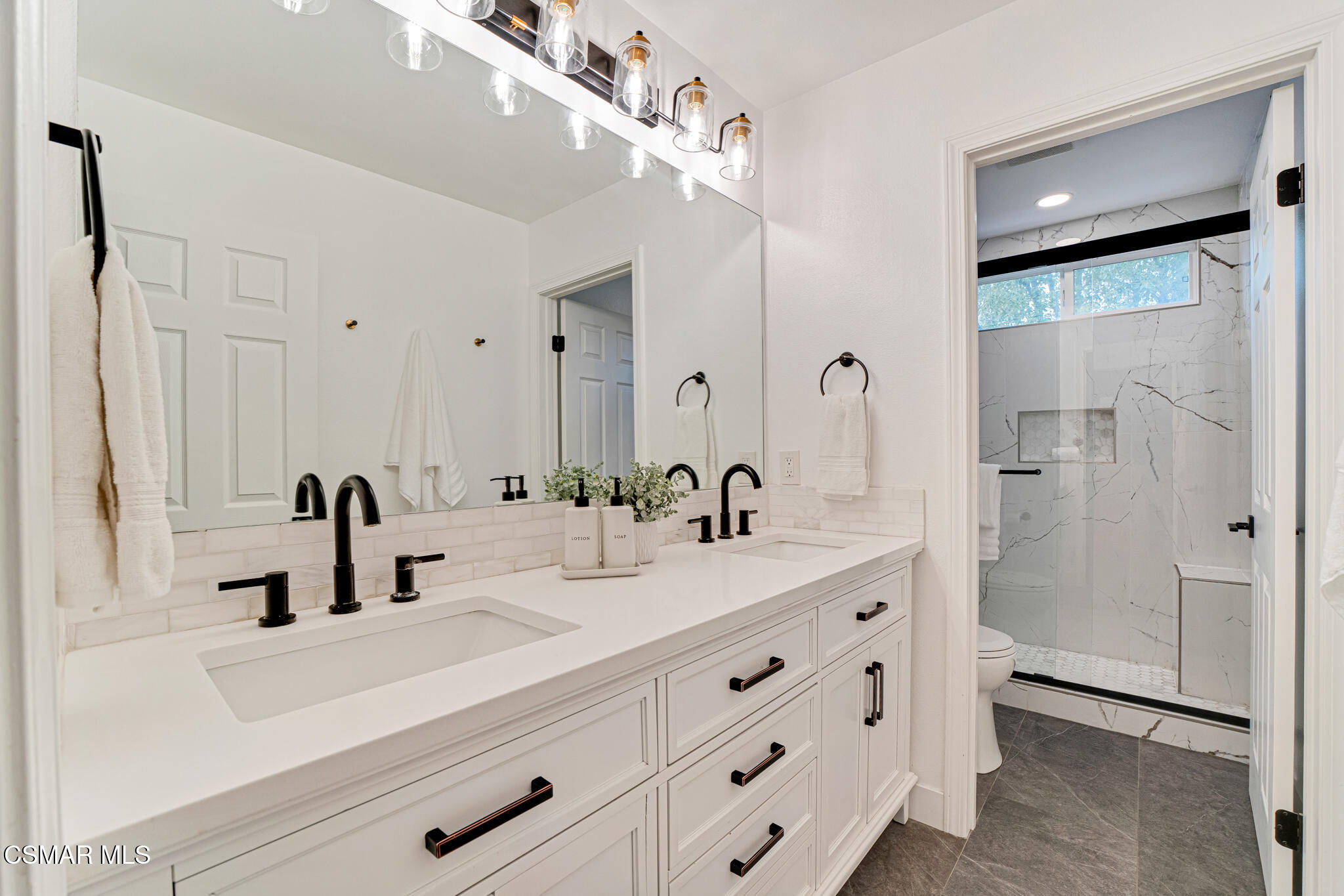 2339 Rudolph Drive Simi Valley, CA 93065 - Photo 29 of 61 a bathroom with double vanity sink a mirror and shower