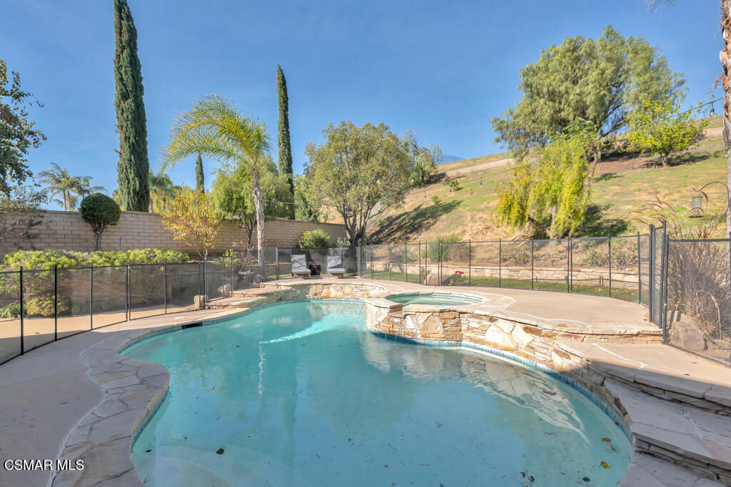 2339 Rudolph Drive Simi Valley, CA 93065 - Photo 39 of 61 a view of a swimming pool with a lawn chairs under an umbrella