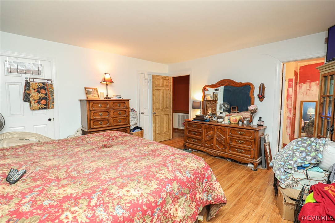 13120 Hensley Road Midlothian, VA 23112 - Photo 20 of 50 a bedroom with a bed and flat screen tv