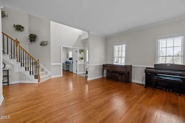 a view of entryway and hall with wooden floor