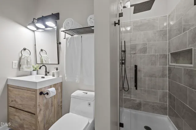 a bedroom with a bed and dresser with mirror