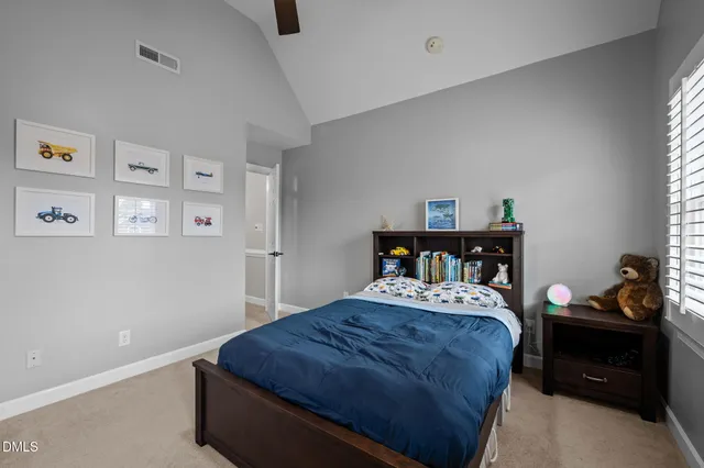 a bedroom with a bed next to a window