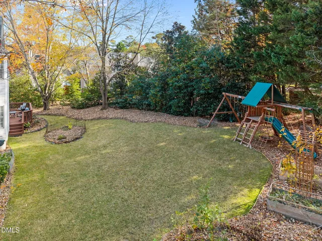 a view of a patio with table and chairs near a yard