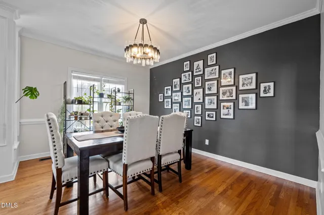 a living room with a couch and a dresser next to a window