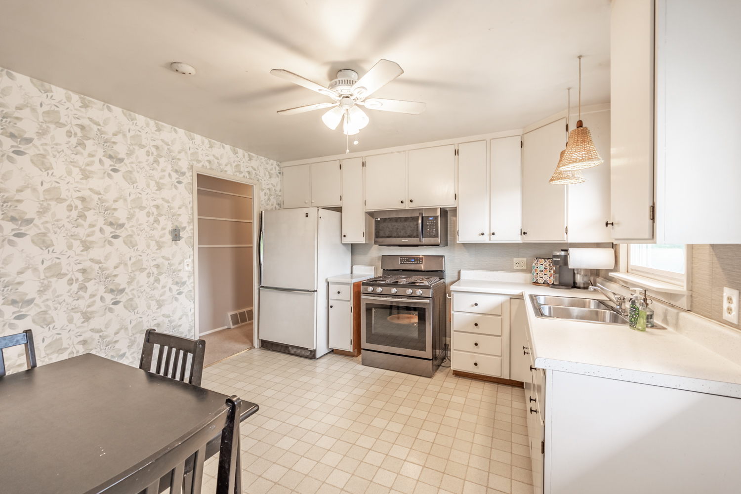 503 Ridge Circle Streamwood, IL 60107 - Photo 7 of 25 a kitchen with stainless steel appliances a stove a sink dishwasher a refrigerator with a dining table and chairs