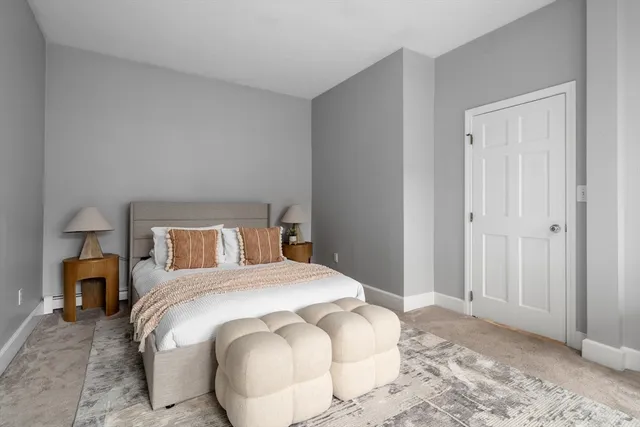 a bedroom with a bed and a lamp