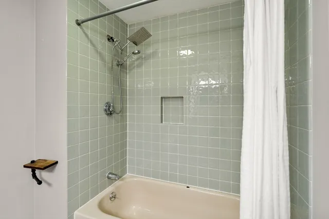 a bathroom with a shower and a bathtub