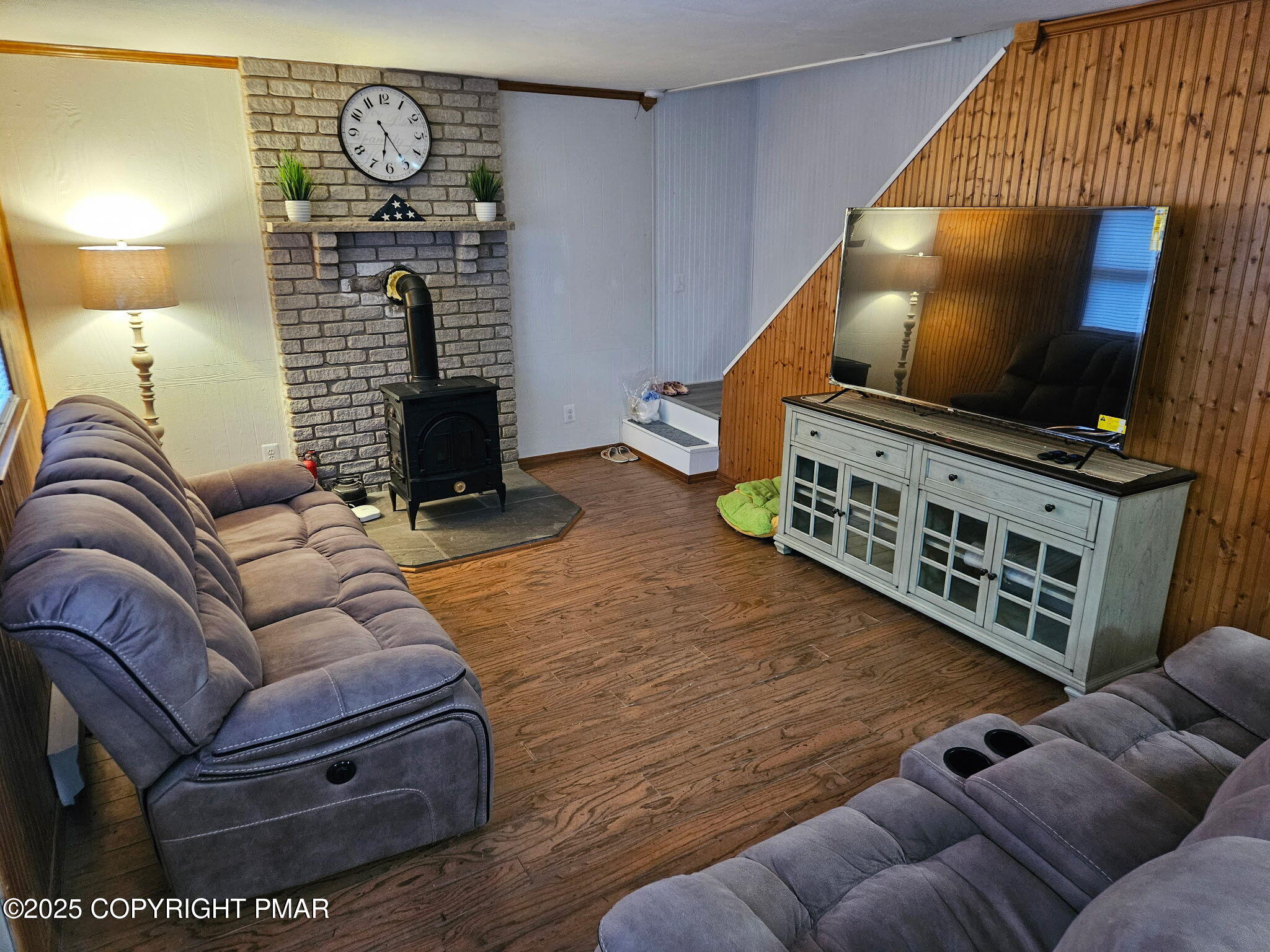222 Nadine Boulevard Pocono Summit, PA 18346 - Photo 5 of 16 a living room with furniture a flat screen tv and a fireplace