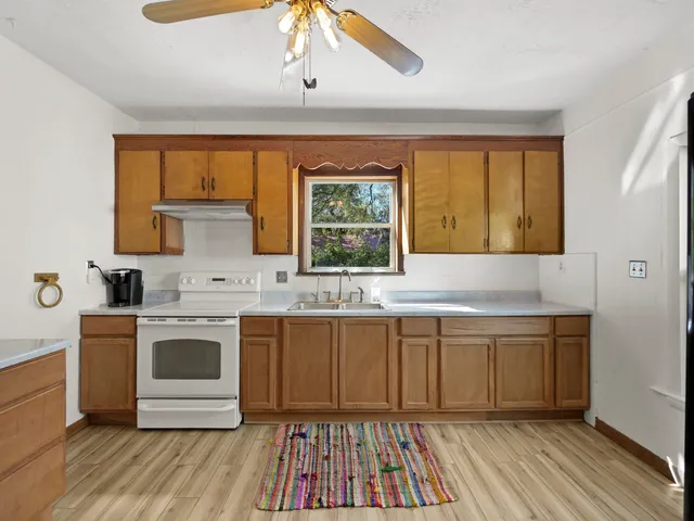 a kitchen with stainless steel appliances a stove a sink and a refrigerator