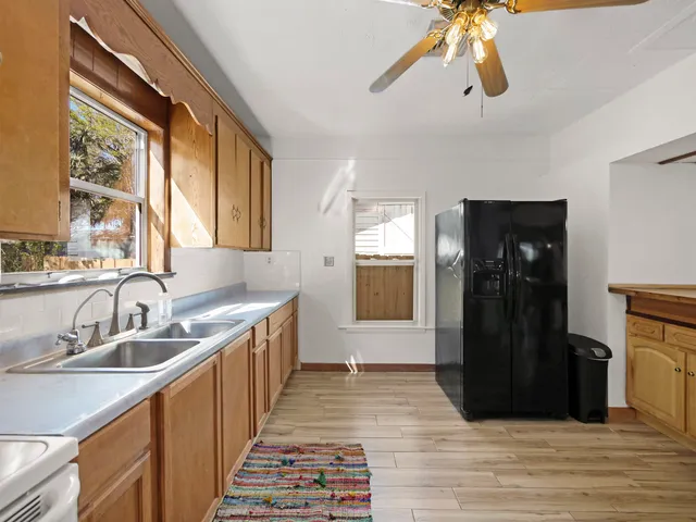 a kitchen with a sink and wooden floor