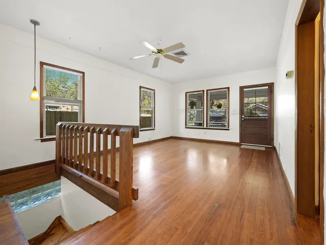 a view of a room with wooden floor and windows