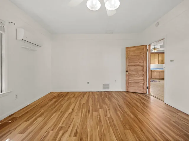a view of a room with wooden floor