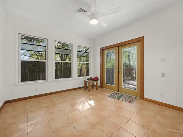 a view of a room with furniture and large windows