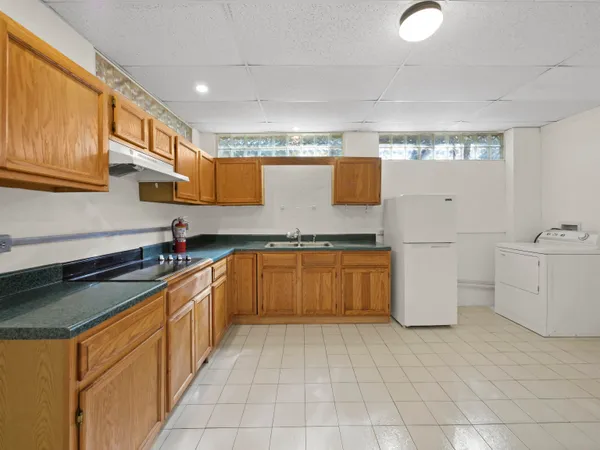 a kitchen with a sink stove and cabinets