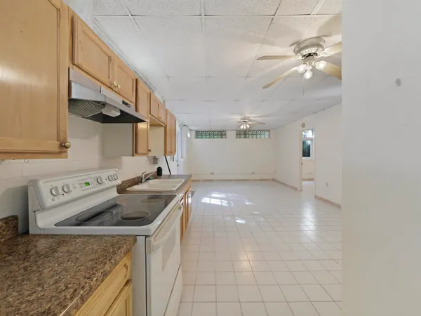 a kitchen that has a sink and a stove