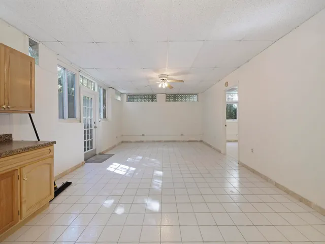 a view of a hallway with entryway and chandelier fan