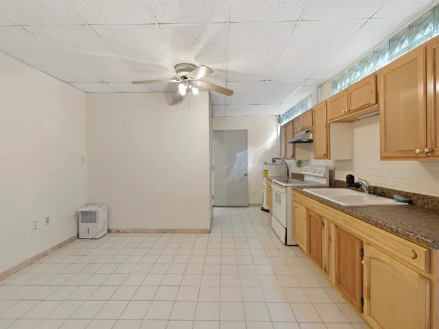 a kitchen with a sink cabinets and appliances