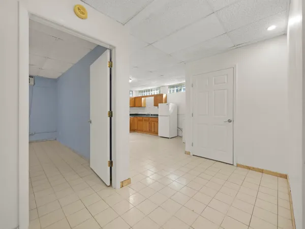 an empty room with a fireplace and cabinet