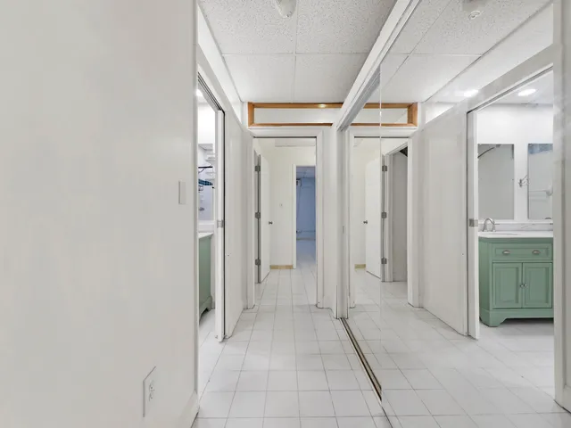 a bathroom with a double vanity sink a mirror and shower