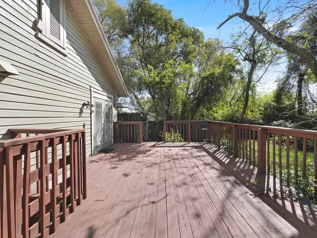 a view of a big house with a big yard and large trees