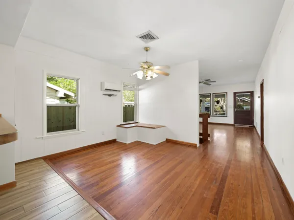 wooden floor in an empty room with a window