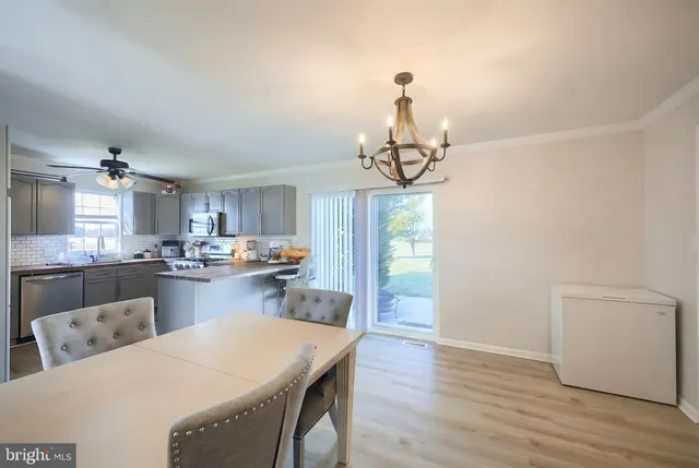 a kitchen with sink refrigerator and cabinets