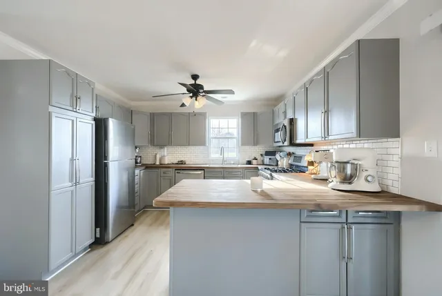 a kitchen with a refrigerator and a sink
