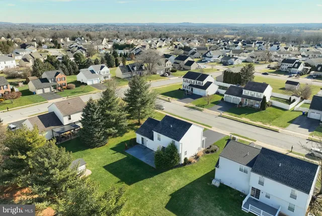 an aerial view of residential houses with outdoor space