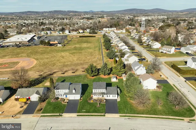 an aerial view of residential building with parking