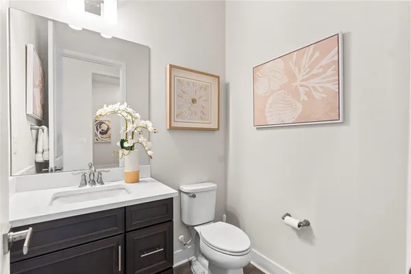 a bathroom with a toilet a sink and mirror