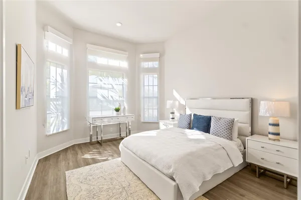 a bedroom with a large bed and a large window