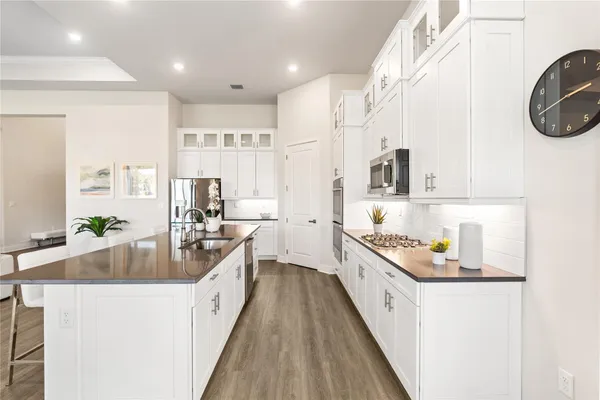 a large kitchen with stainless steel appliances lots of counter space and a sink