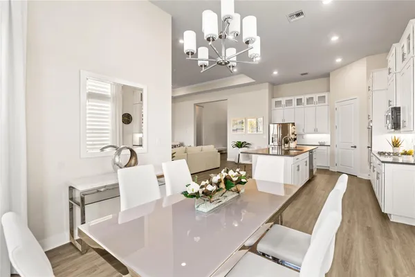 a living room with furniture or kitchen and a chandelier
