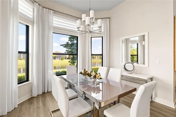 a view of a dining room with furniture wooden floor and chandelier