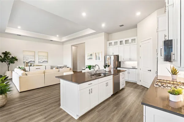 a kitchen with sink and white cabinets
