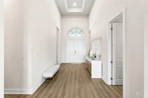 a view of a hallway with wooden floor and staircase