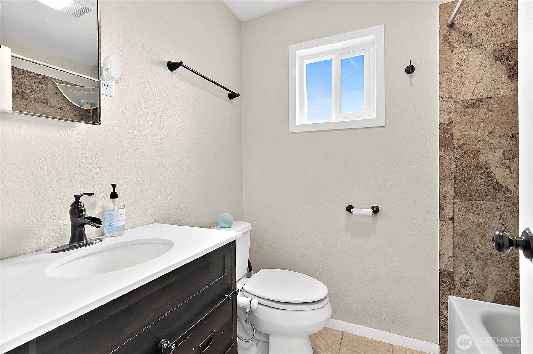 7308 Riverside Road East Sumner, WA 98390 - Photo 16 of 24 a bathroom with a sink a toilet and shower