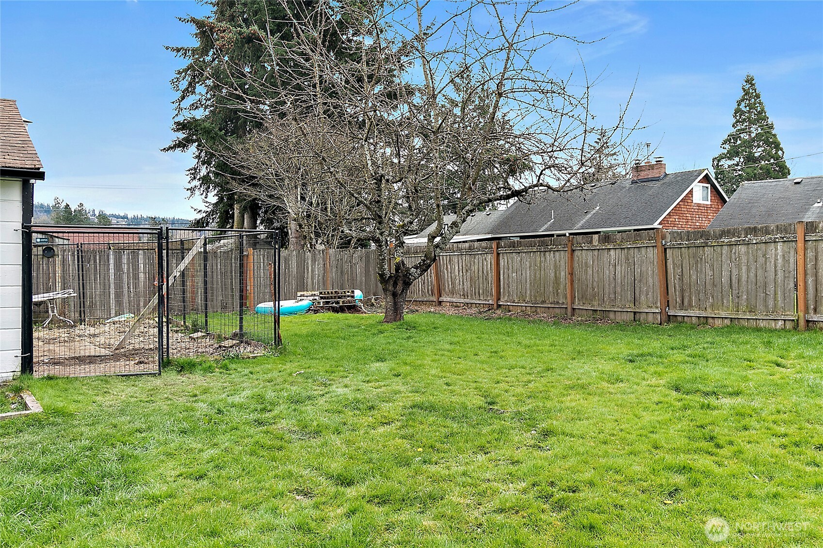 7308 Riverside Road East Sumner, WA 98390 - Photo 23 of 24 a view of a backyard with a garden and entertaining space