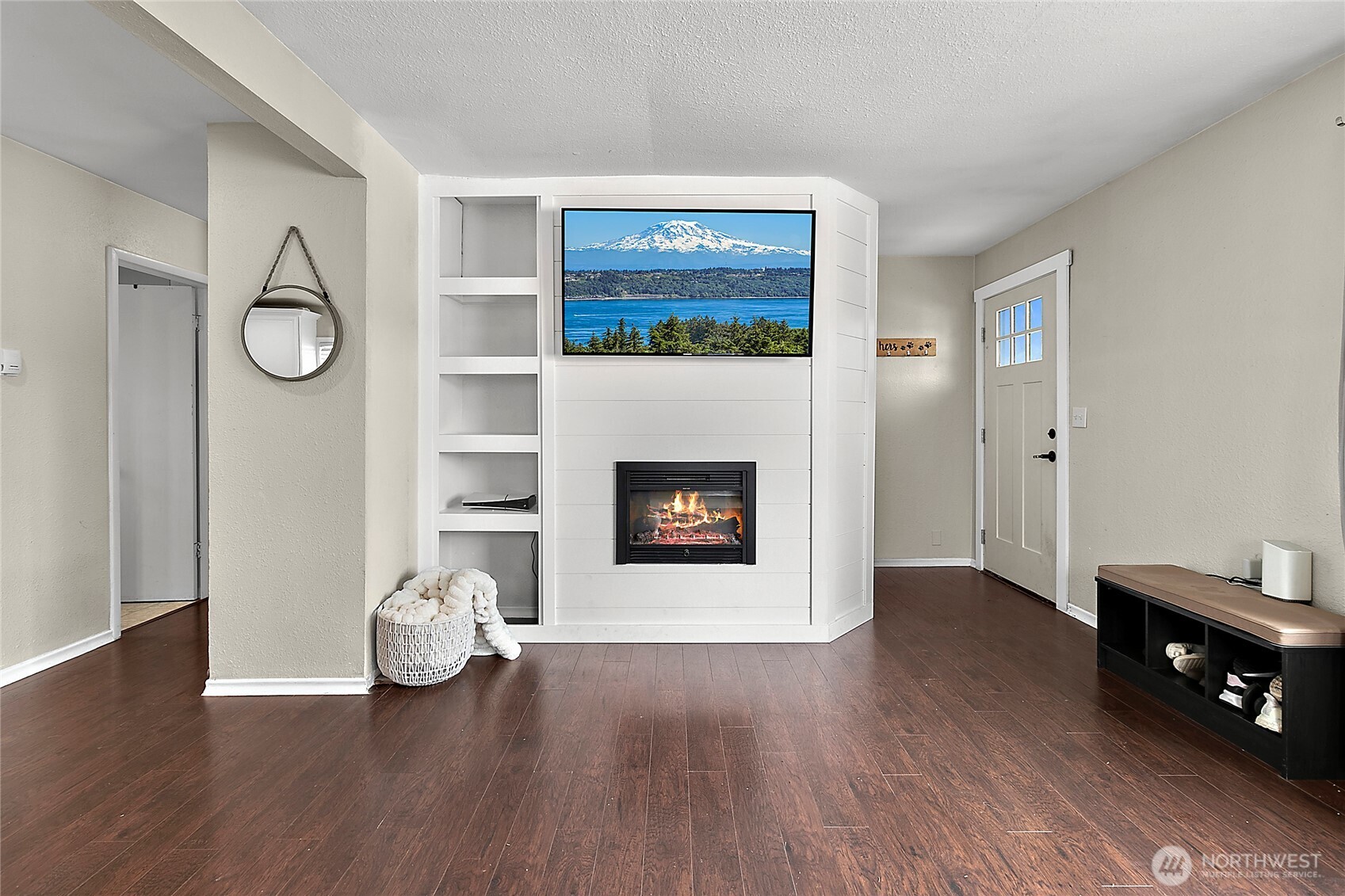 7308 Riverside Road East Sumner, WA 98390 - Photo 6 of 24 a view of an empty room with wooden floor and a fireplace