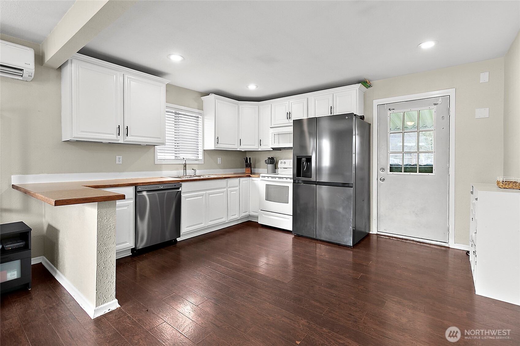 7308 Riverside Road East Sumner, WA 98390 - Photo 10 of 24 a kitchen with stainless steel appliances granite countertop a refrigerator and a stove top oven