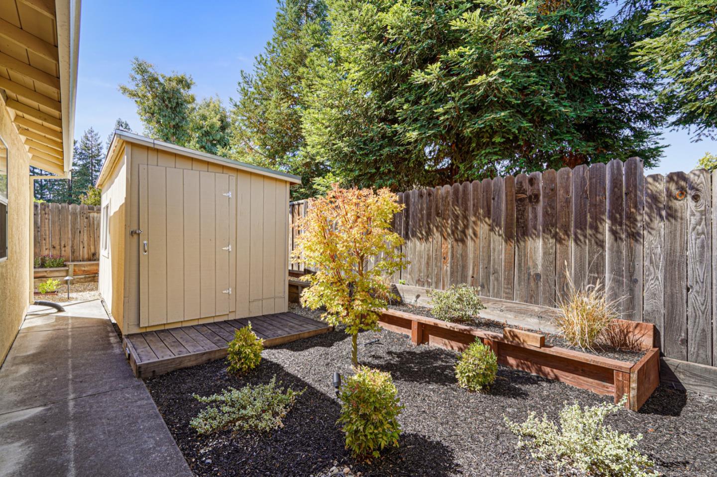 928 Lynn Court San Ramon, CA 94583 - Photo 39 of 43 a backyard of a house with a large tree and wooden fence