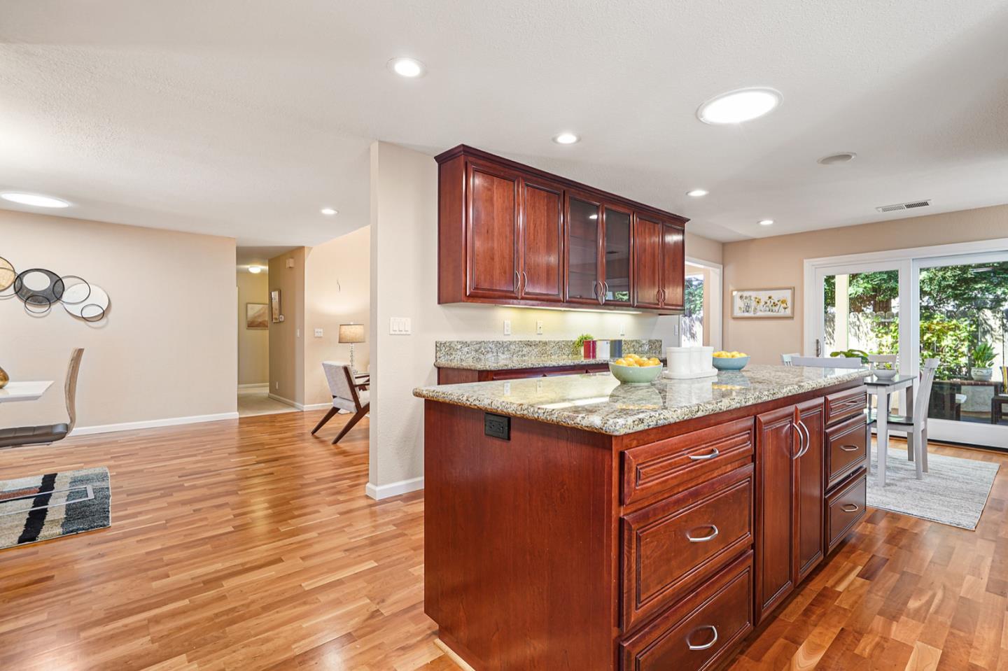 928 Lynn Court San Ramon, CA 94583 - Photo 9 of 43 a kitchen with granite countertop a stove top oven a sink dishwasher and a refrigerator with wooden floor