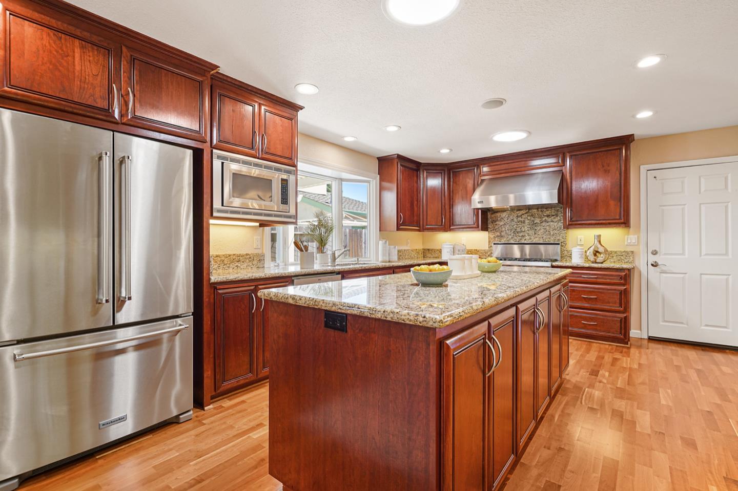 928 Lynn Court San Ramon, CA 94583 - Photo 10 of 43 a kitchen with stainless steel appliances granite countertop a refrigerator a sink dishwasher a stove and a wooden cabinets
